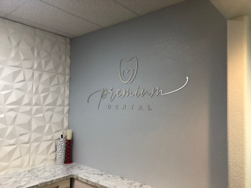 Brushed Metal Lobby Logo Sign Welcomes Visitors to Irvine CA Dentistry